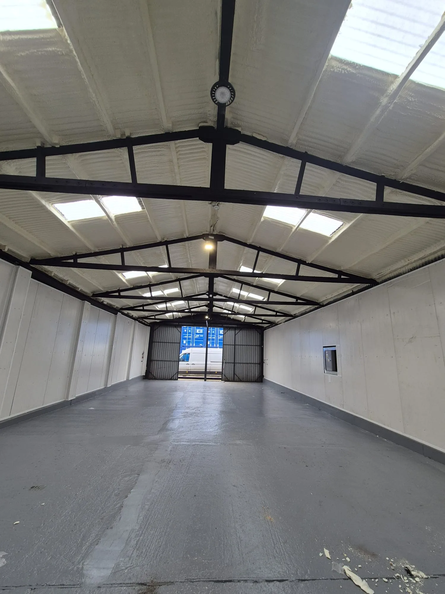 The roof and steel frame within an agricultural building.