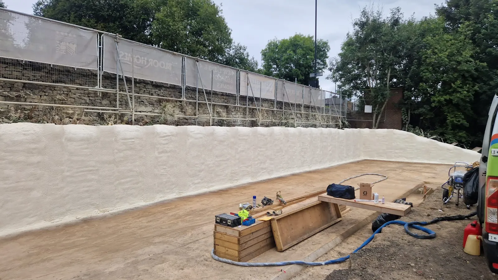 Spray foam insulation applied to piled walls — real Duratite Group project