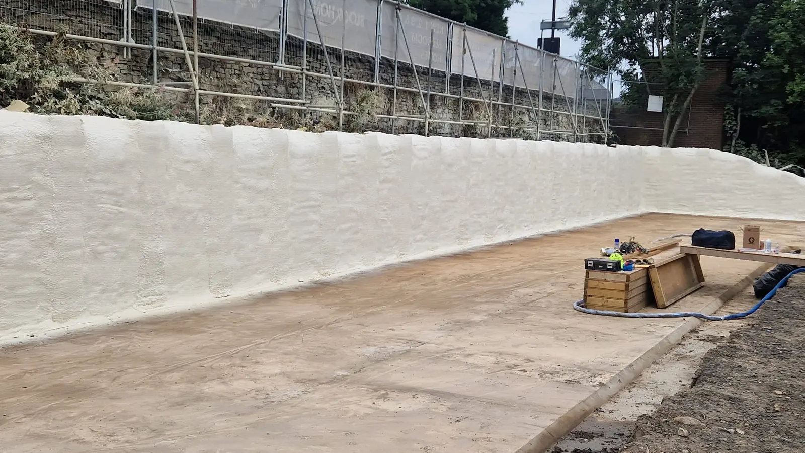 Spray foam insulation applied to piled walls — real Duratite Group project