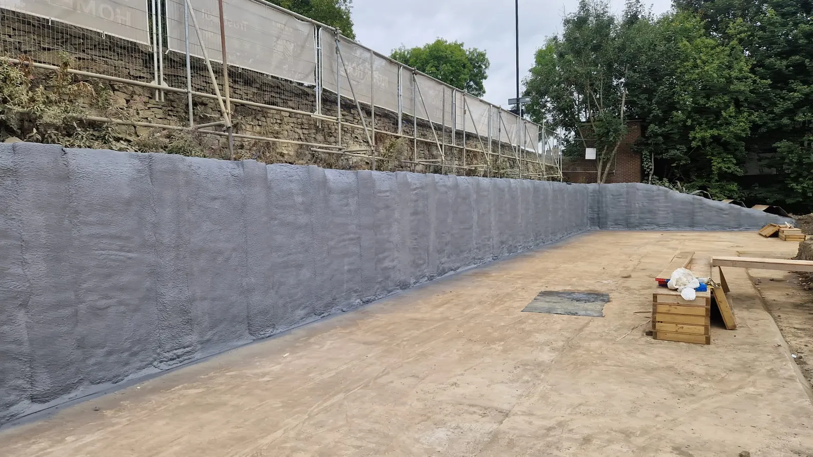 Spray foam insulation applied to piled walls — real Duratite Group project