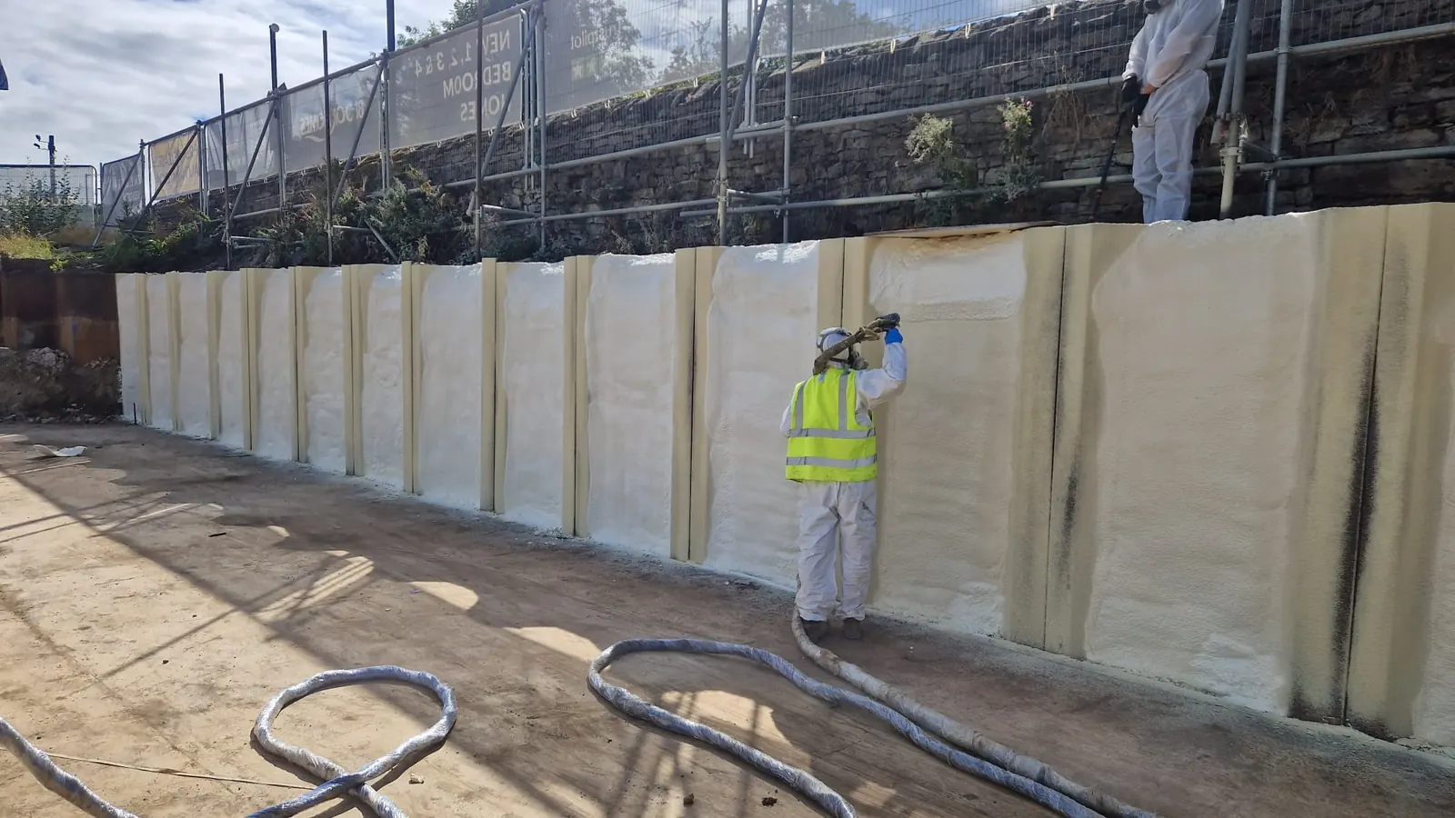 Spray foam insulation applied to piled walls — real Duratite Group project