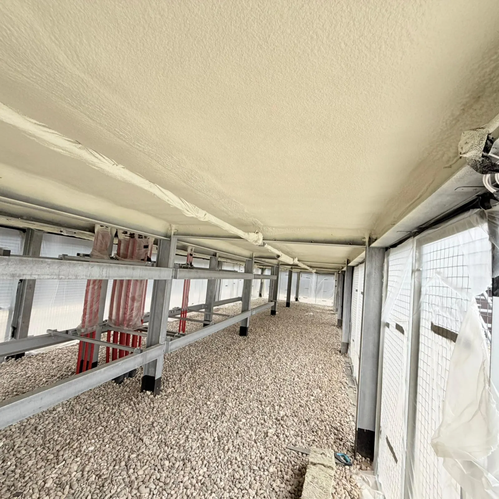 Closed-cell spray foam on a commercial soffit — a decades-long service life