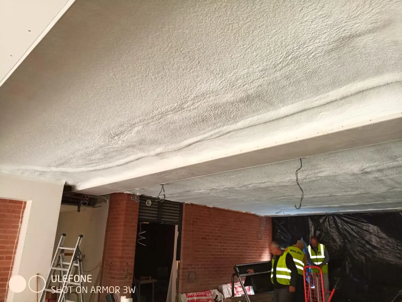Spray foam insulation applied to ceiling voids — real Duratite Group project
