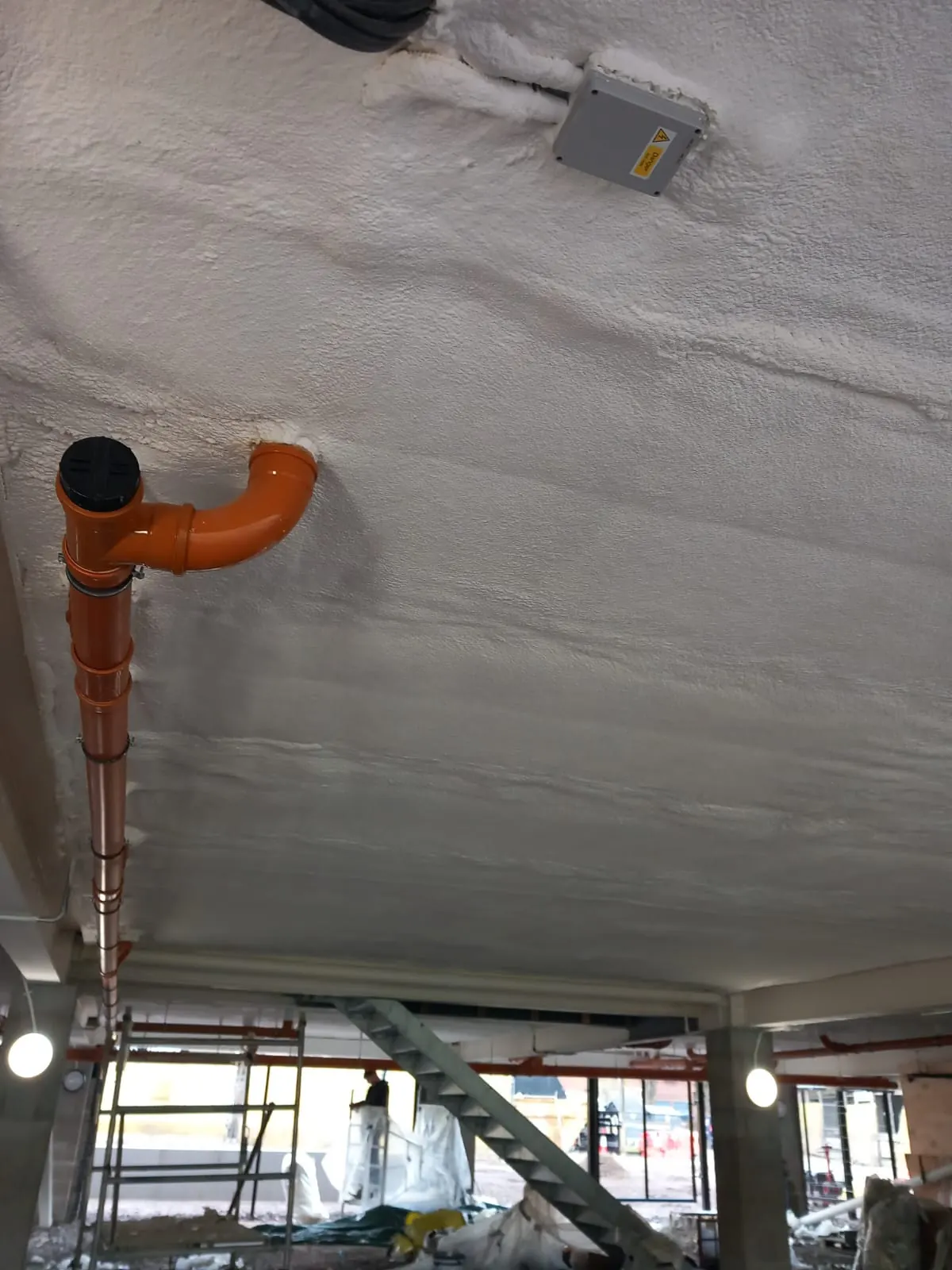 Spray foam insulation applied to ceiling voids — real Duratite Group project