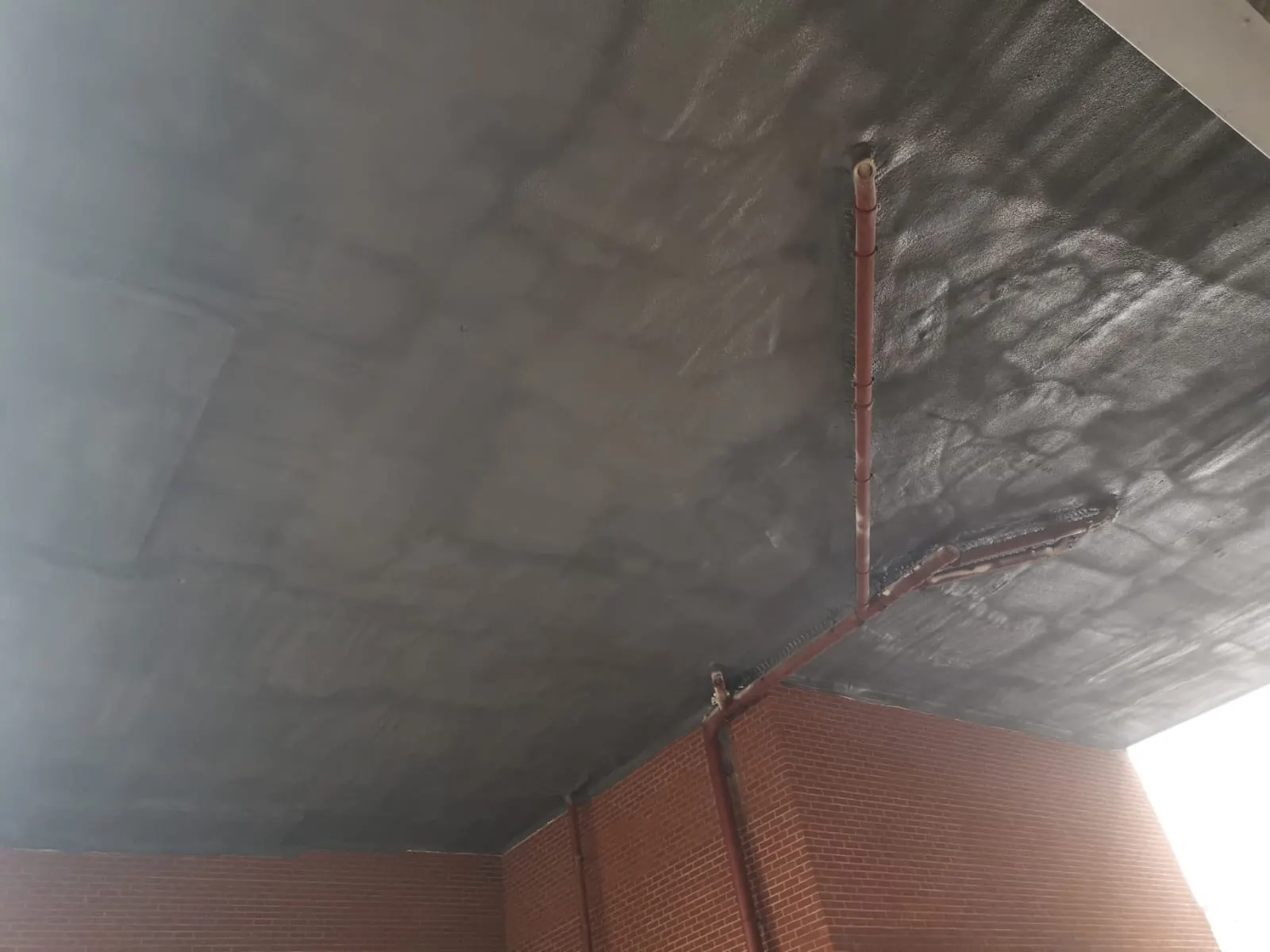 Spray foam insulation applied to ceiling voids — real Duratite Group project