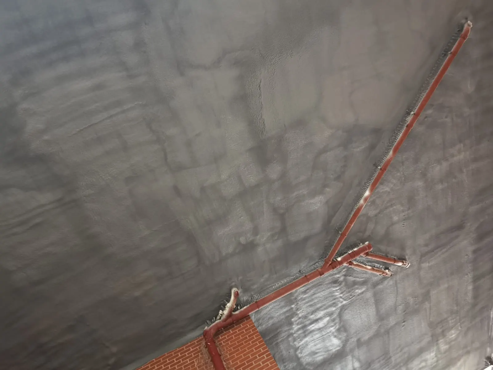 Spray foam insulation applied to ceiling voids — real Duratite Group project