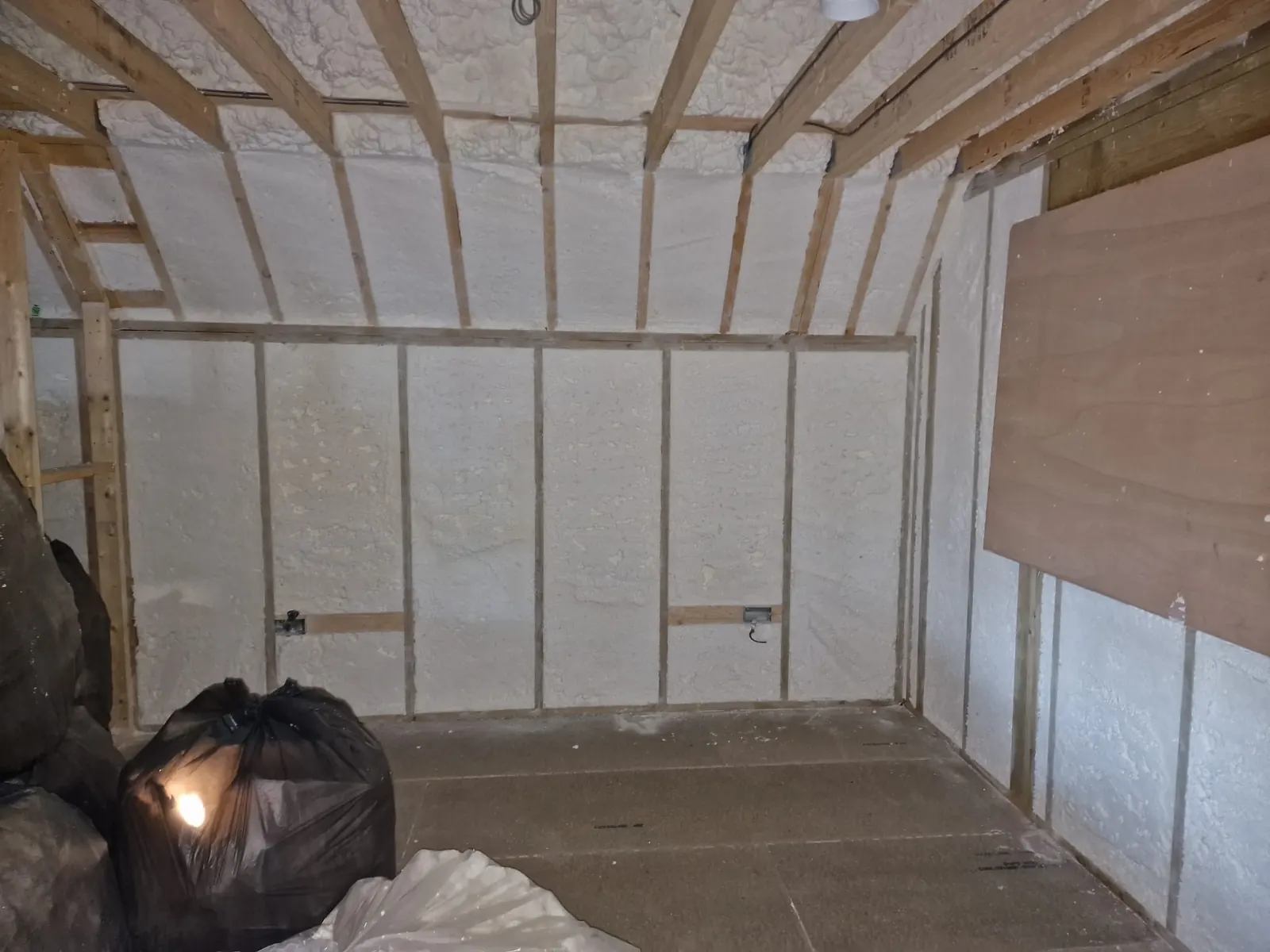 Open-cell spray foam filling a timber frame completely, with no gaps